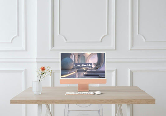 Modern computer setup on a desk with a decorative wall in the background